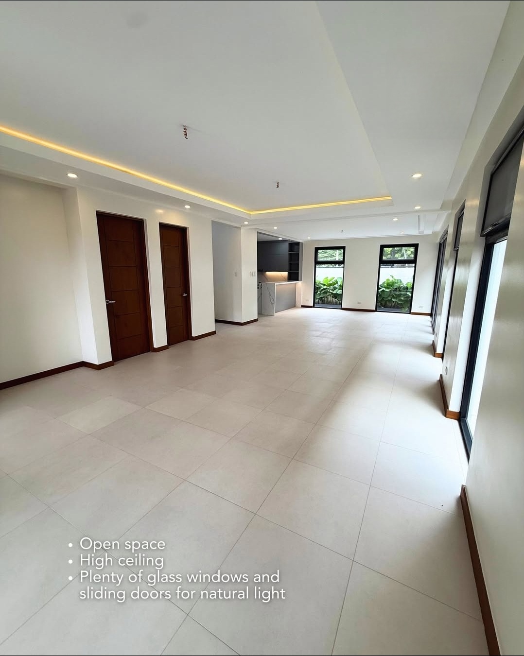 Open living area with wood doors and natural light
