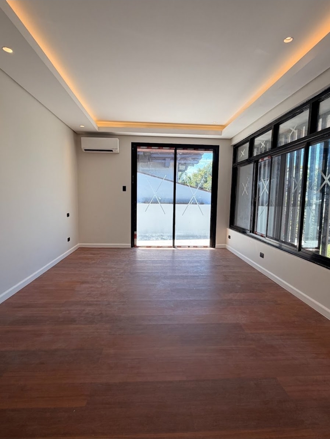 Bright bedroom with hardwood floors and sliding glass doors