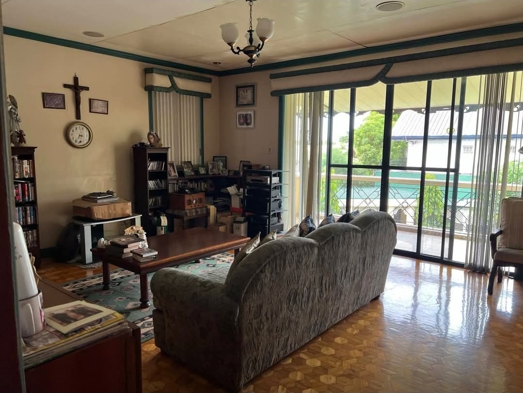 Family living room opening to a garden lanai through floor-to-ceiling glass