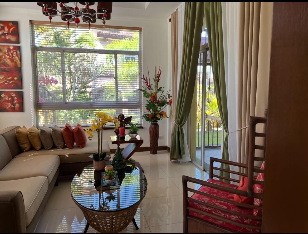 Living area opening to the covered lanai and landscaped garden