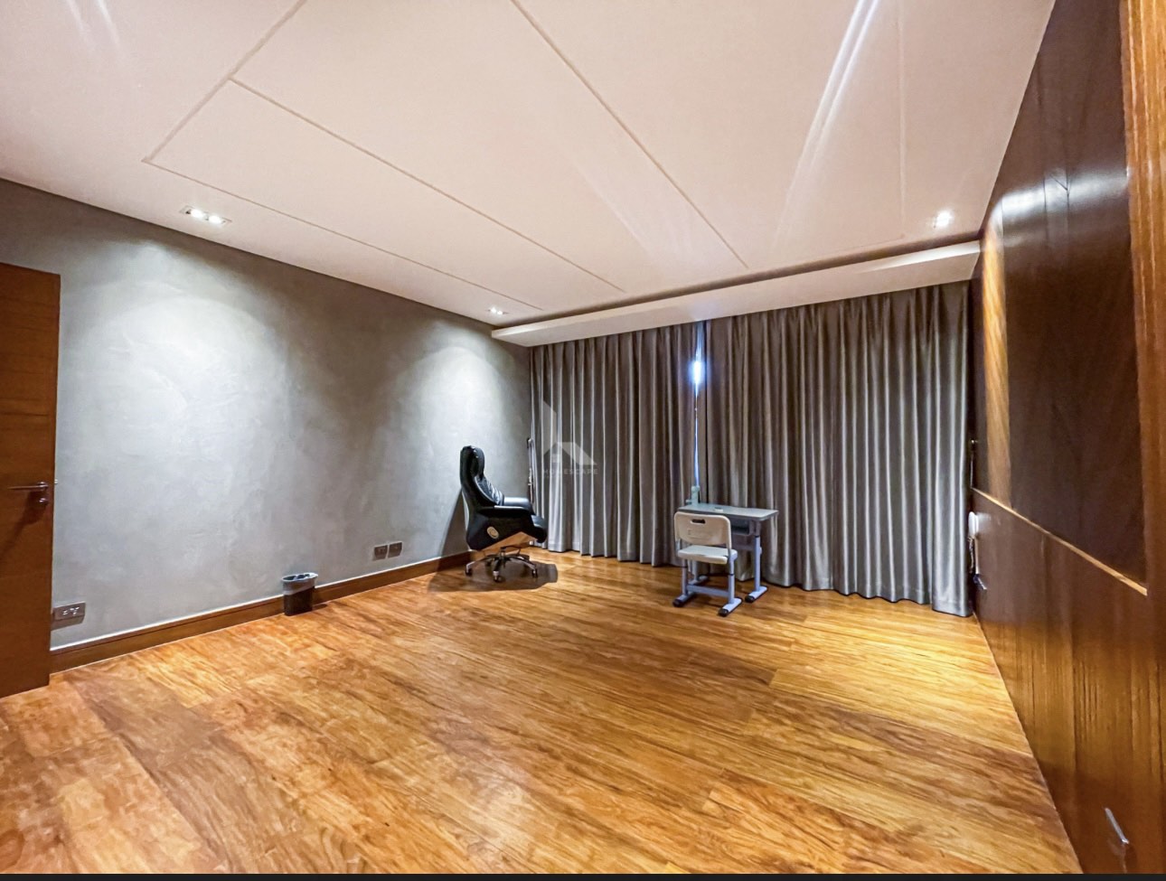 Study room with hardwood floors and full-height drapery