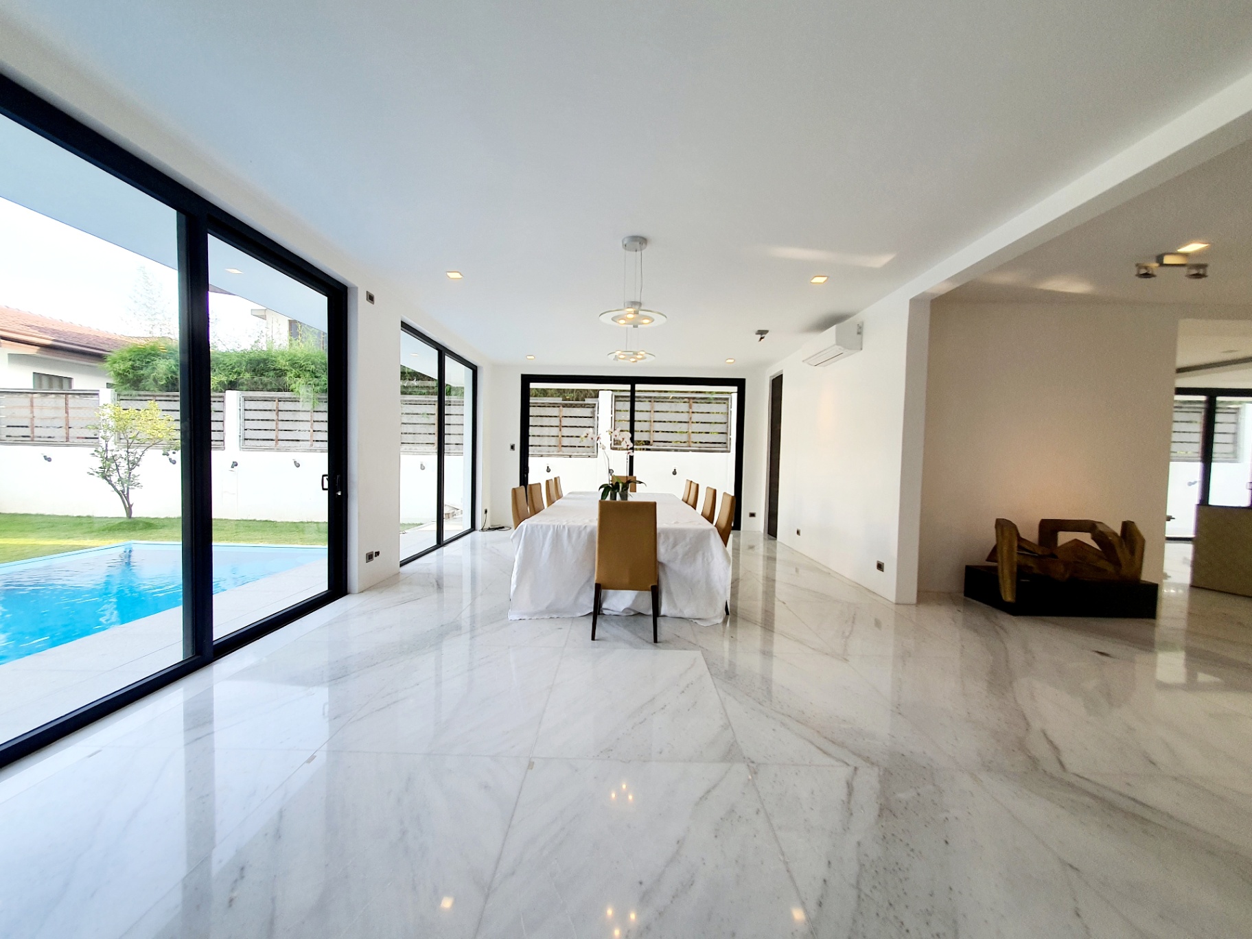 Living and dining space opening to the swimming pool