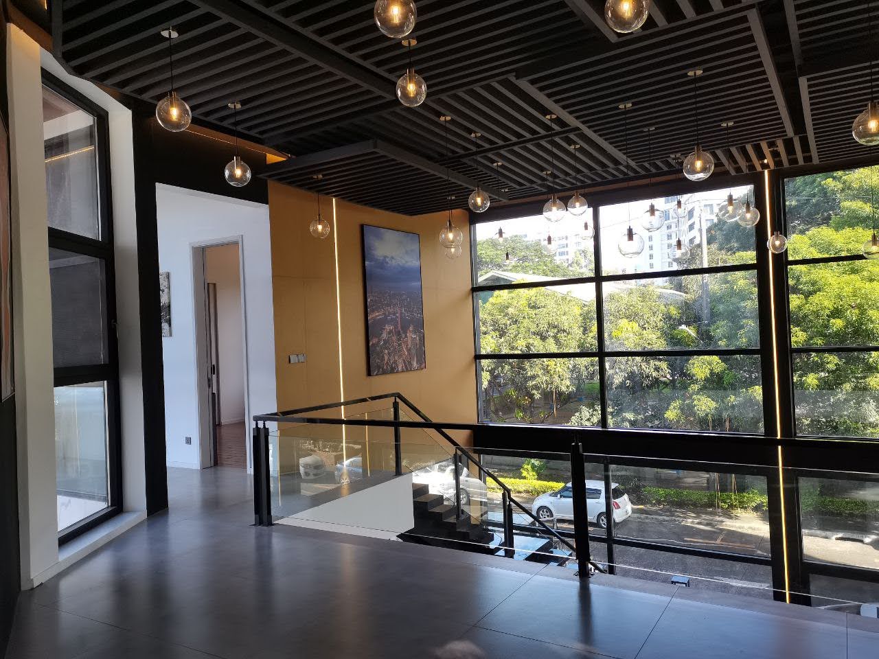 Upper landing with glass balustrade and pendant lighting