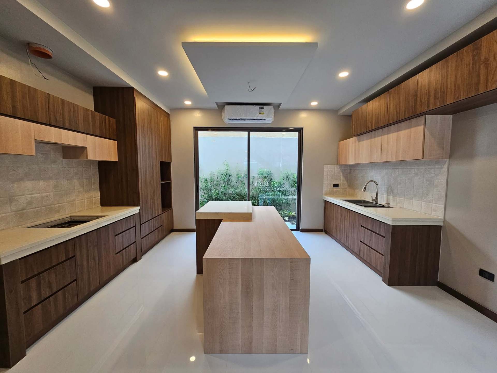 Main kitchen with built-in appliances and waterfall island