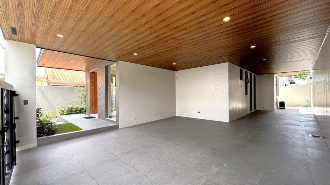 3-car garage with warm wood ceiling and side garden entry