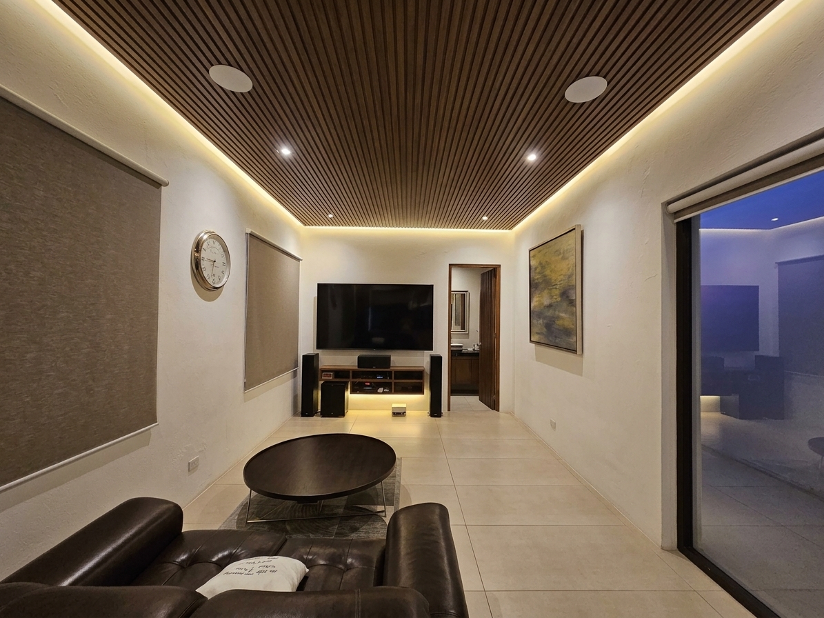 Dedicated private home theater with timber slat ceiling and surround speakers