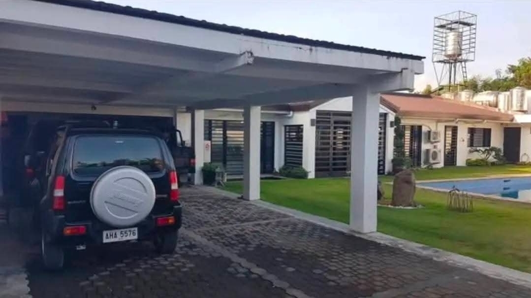 Covered carport and driveway with elevated water tank