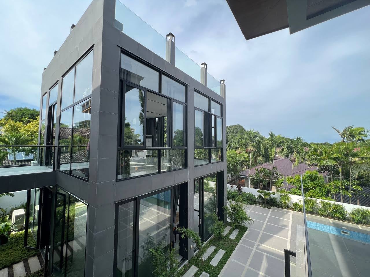 Rear elevation with layered balconies overlooking the pool