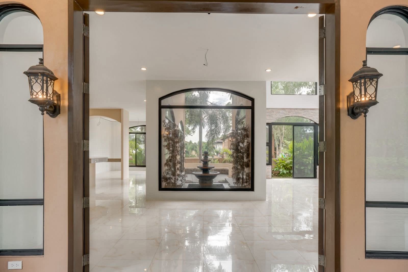 Grand foyer framing the central atrium fountain through a picture window