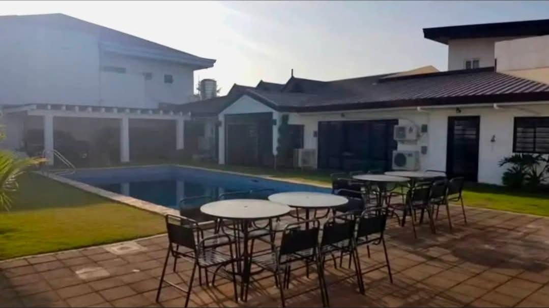 Poolside patio with dining sets and covered lanai