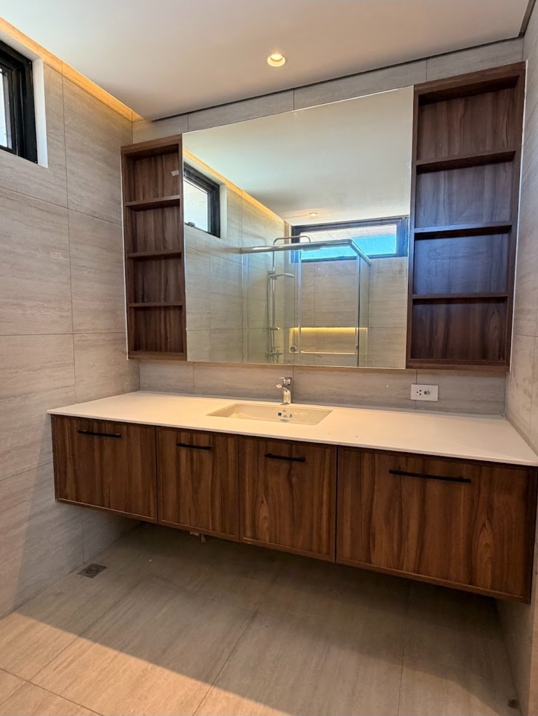 Bathroom vanity with wood cabinetry, mirror, and open shelving