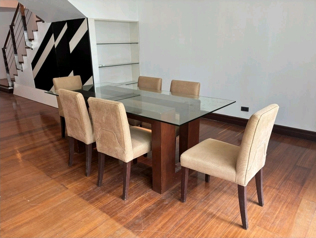 Dining setting with feature wall and staircase to the bedrooms