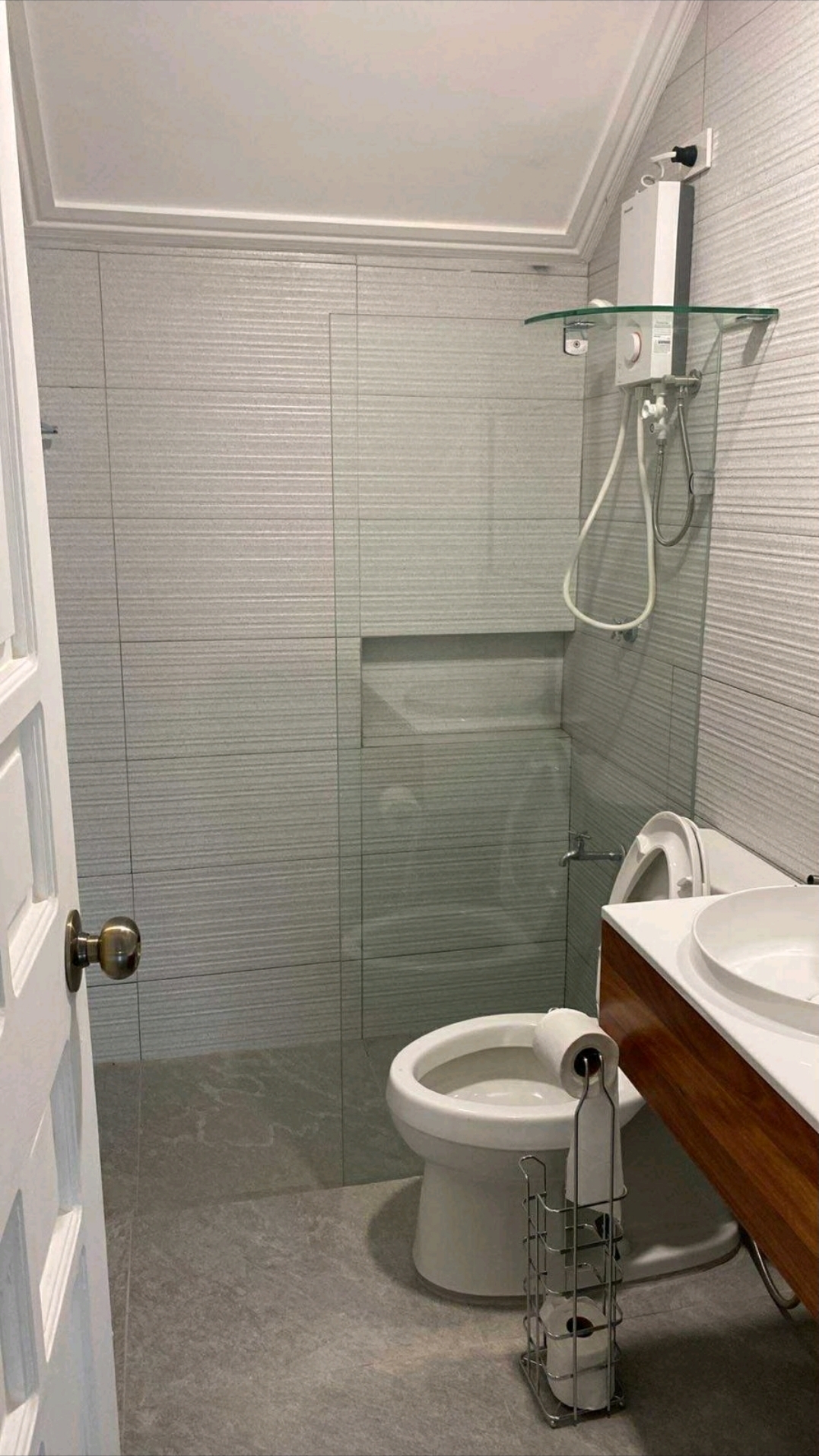 Renovated bathroom with glass shower enclosure
