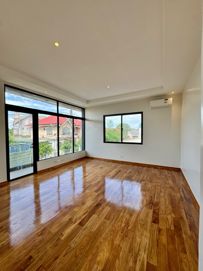 Spacious bedroom with narra flooring and wide windows
