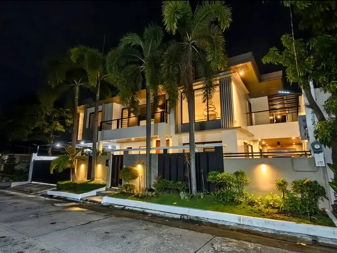 Illuminated facade of the corner home at night