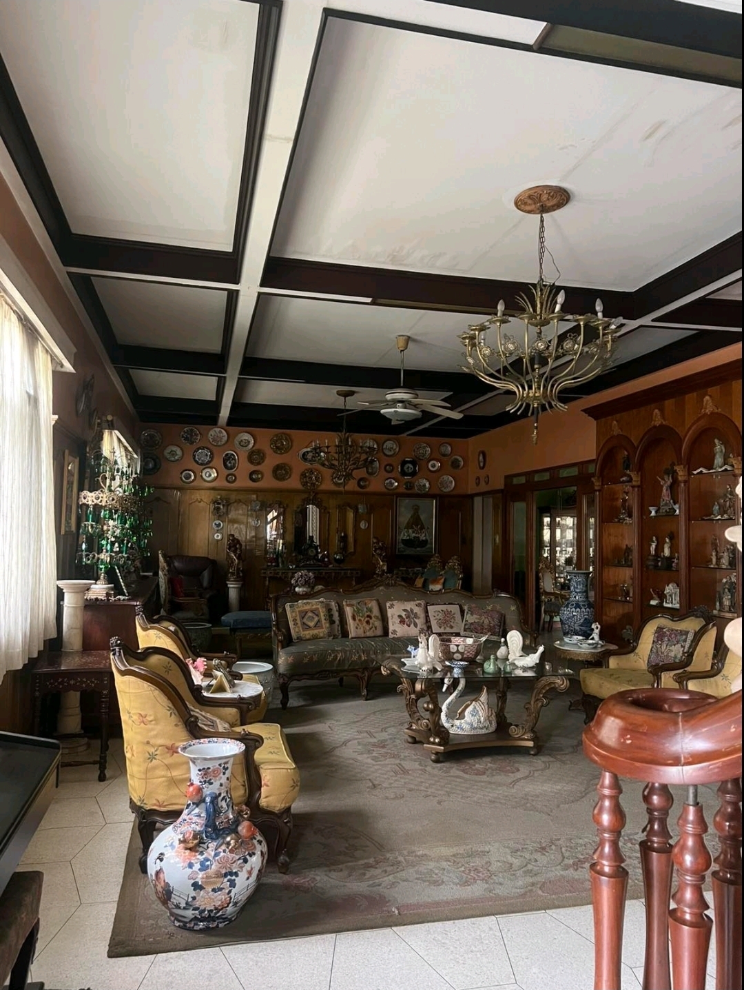 Formal living room with coffered ceiling and antique furnishings