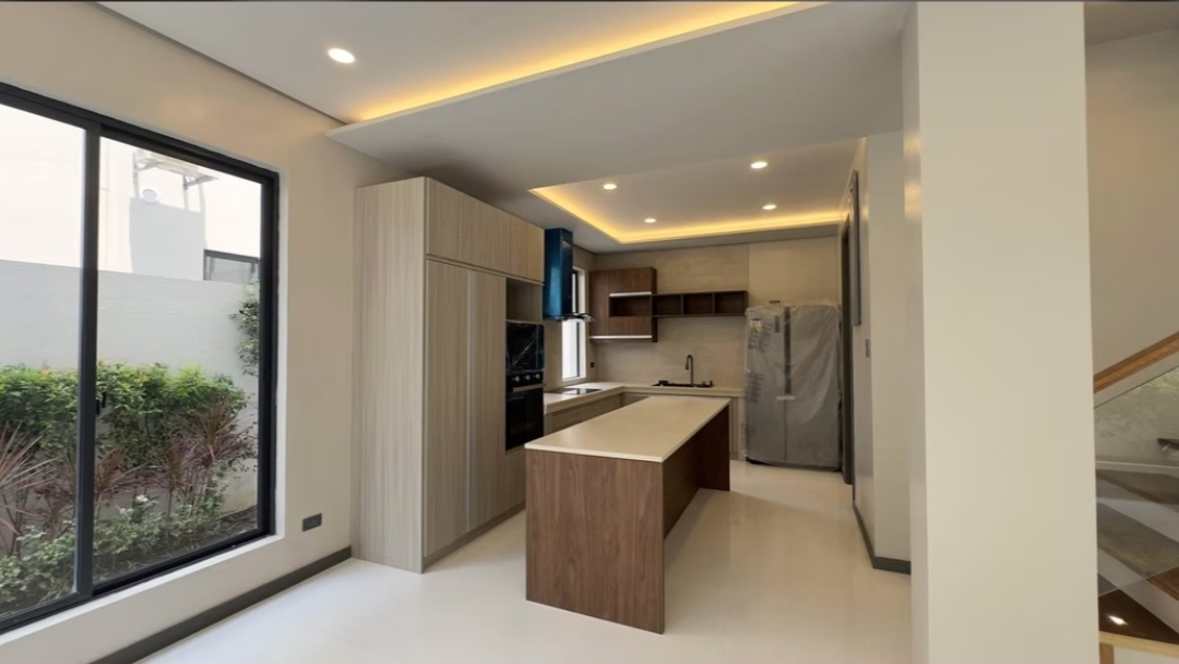 Main kitchen with wood cabinetry, island, and built-in appliances