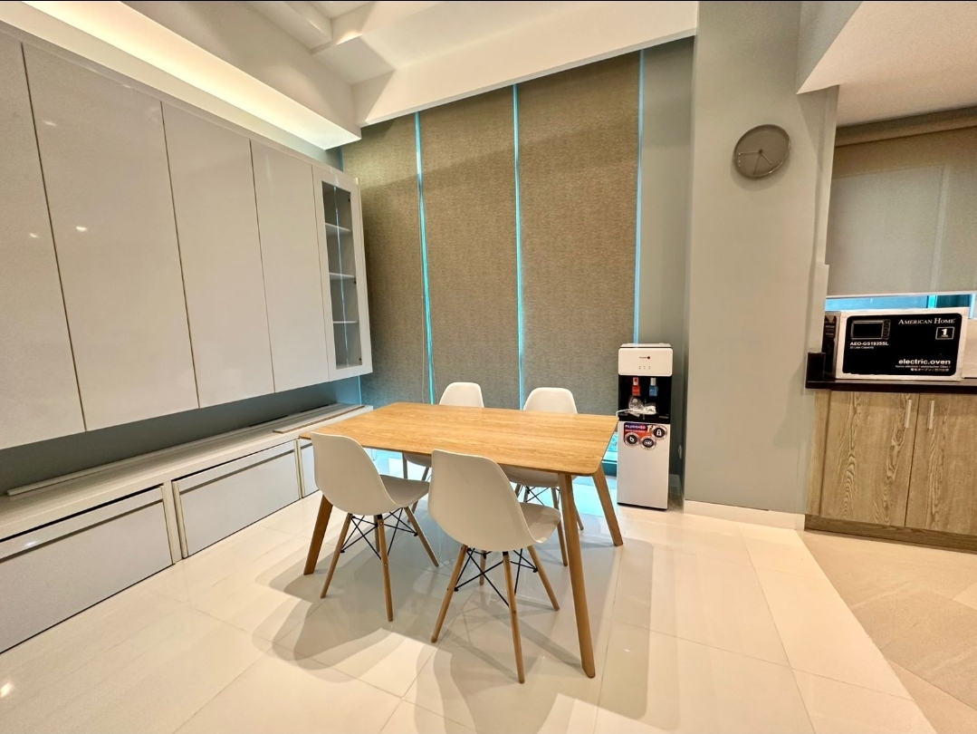 Dining area with high-gloss cabinetry and Eames-style chairs