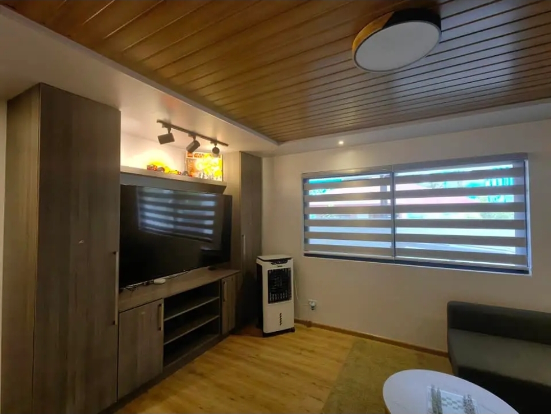 Cozy media room with wall-mounted TV and built-in cabinetry