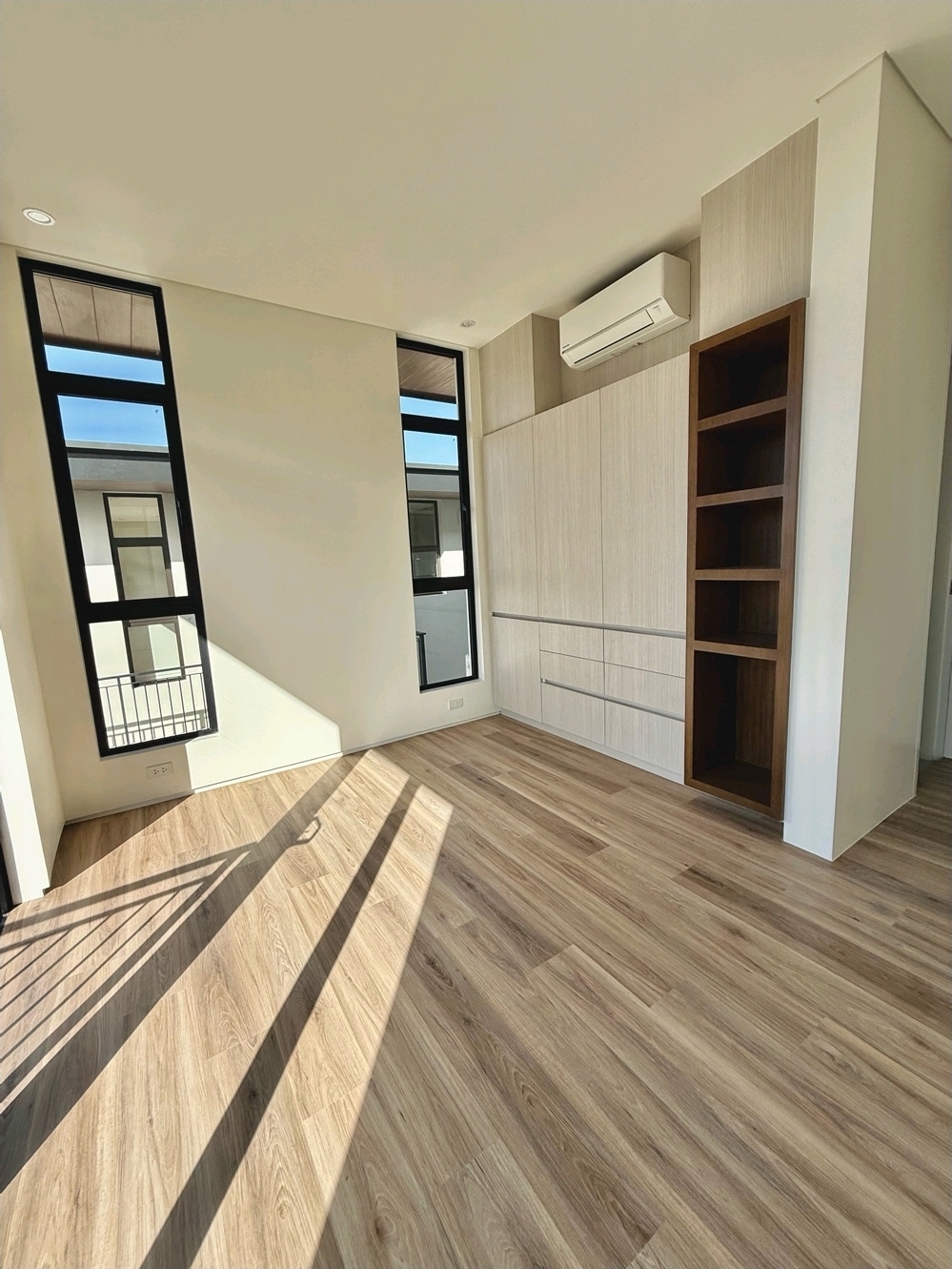 Bedroom with tall windows and fitted wardrobes