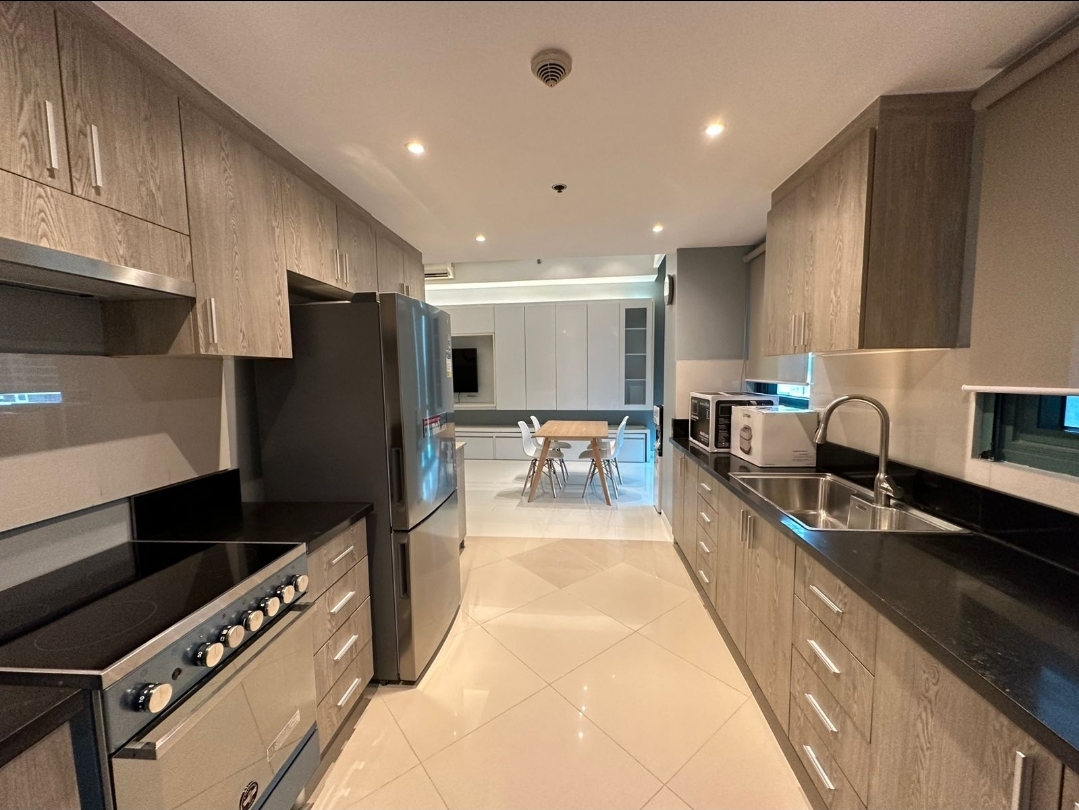 Galley kitchen with stainless appliances and stone counters