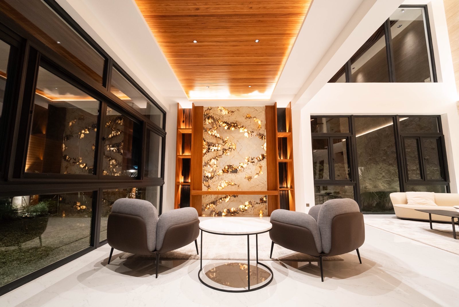 Lanai lounge with backlit marble wall and designer seating