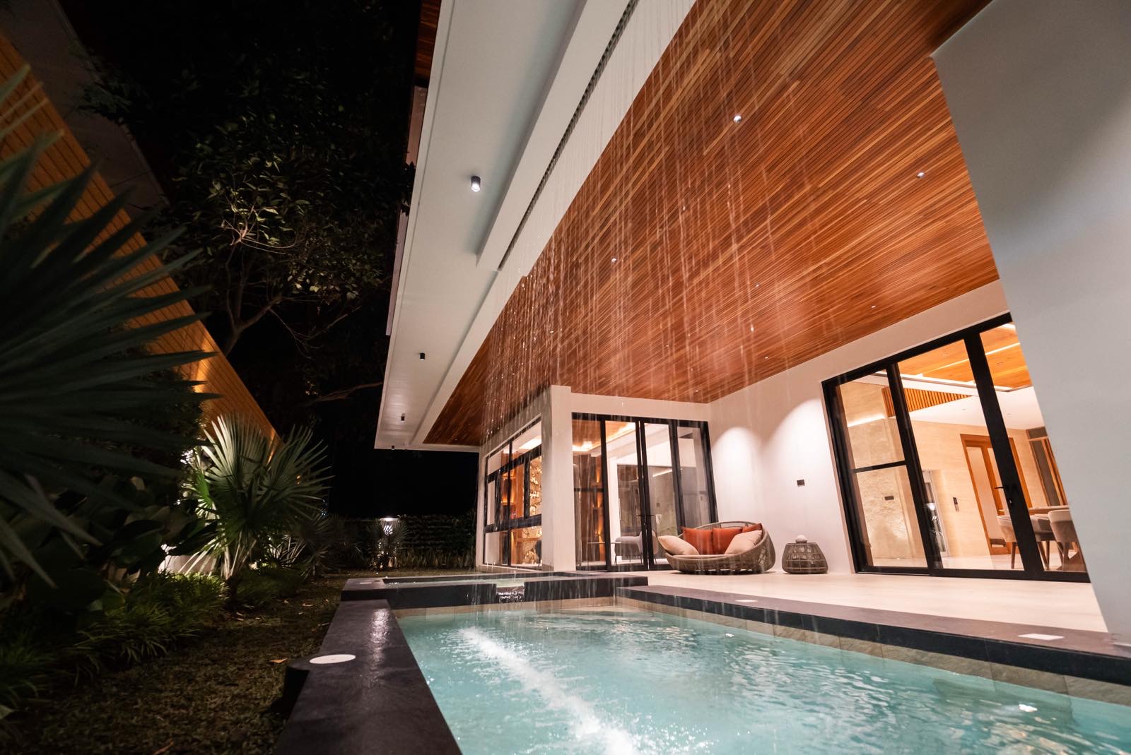 Swimming pool with concealed curtain waterfall and lanai