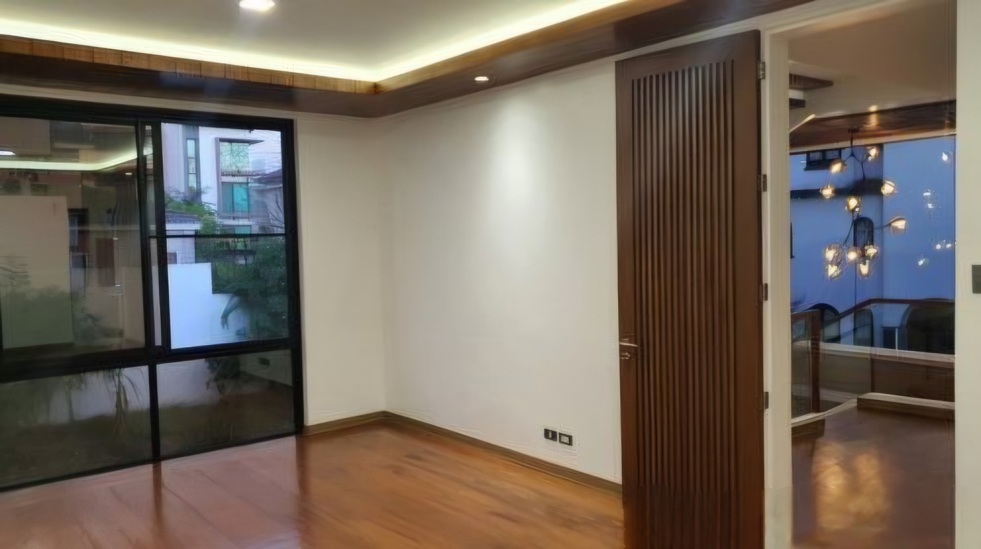 Room with wood-slat sliding door and balcony view