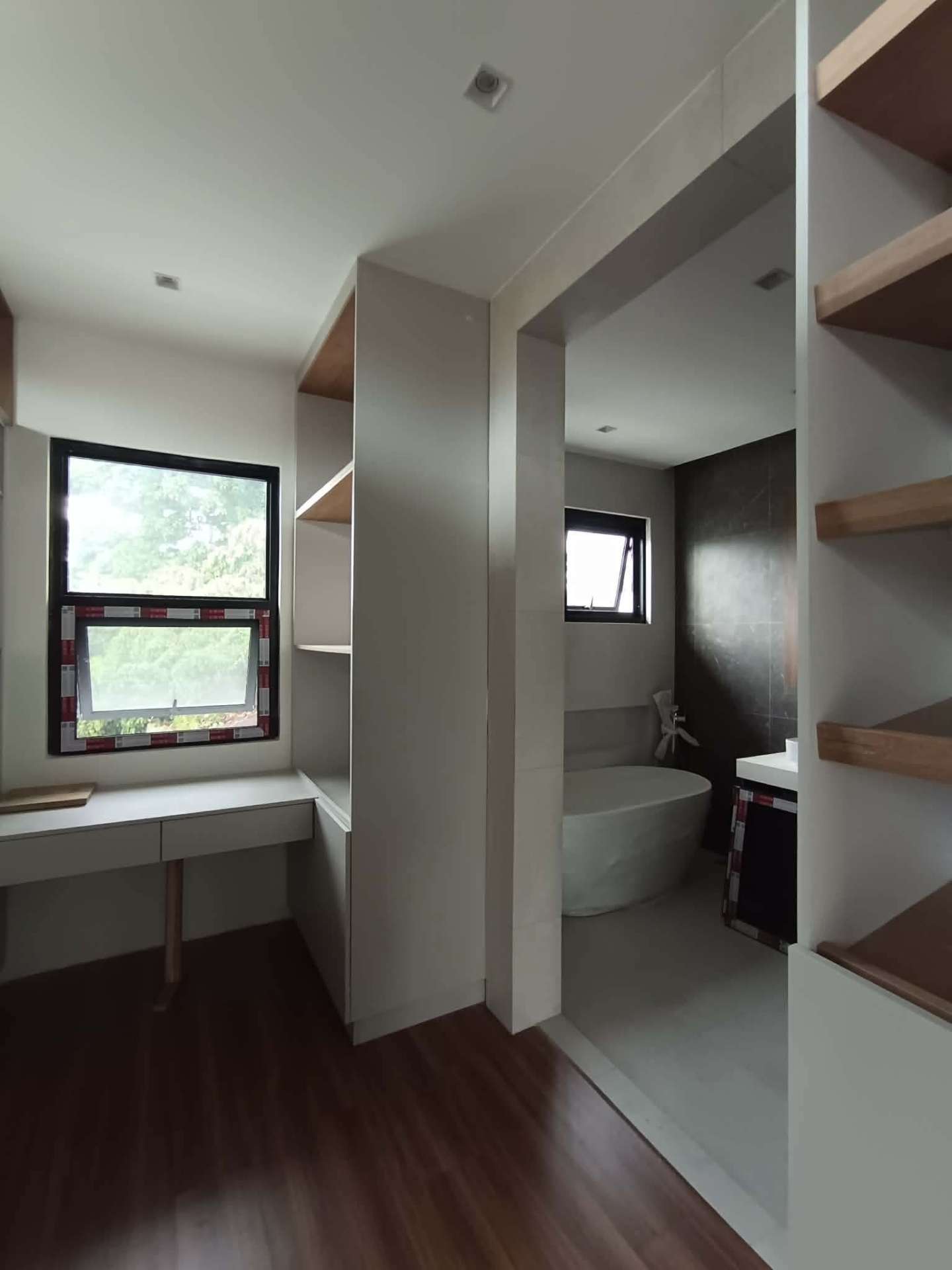 Modern bath with wood accents, soaking tub, and walk-in shower