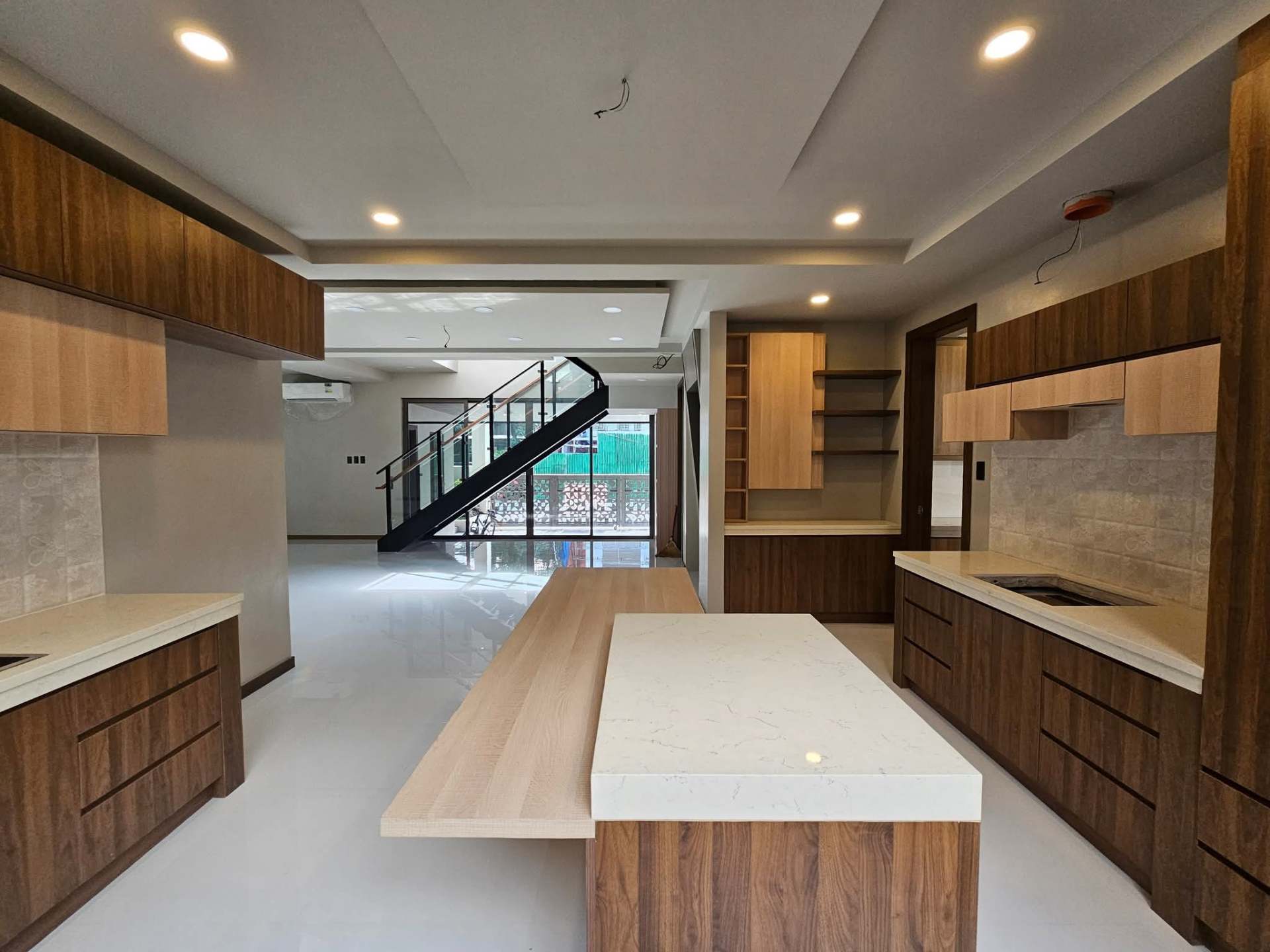 Kitchen and dining area with dual islands and open shelving