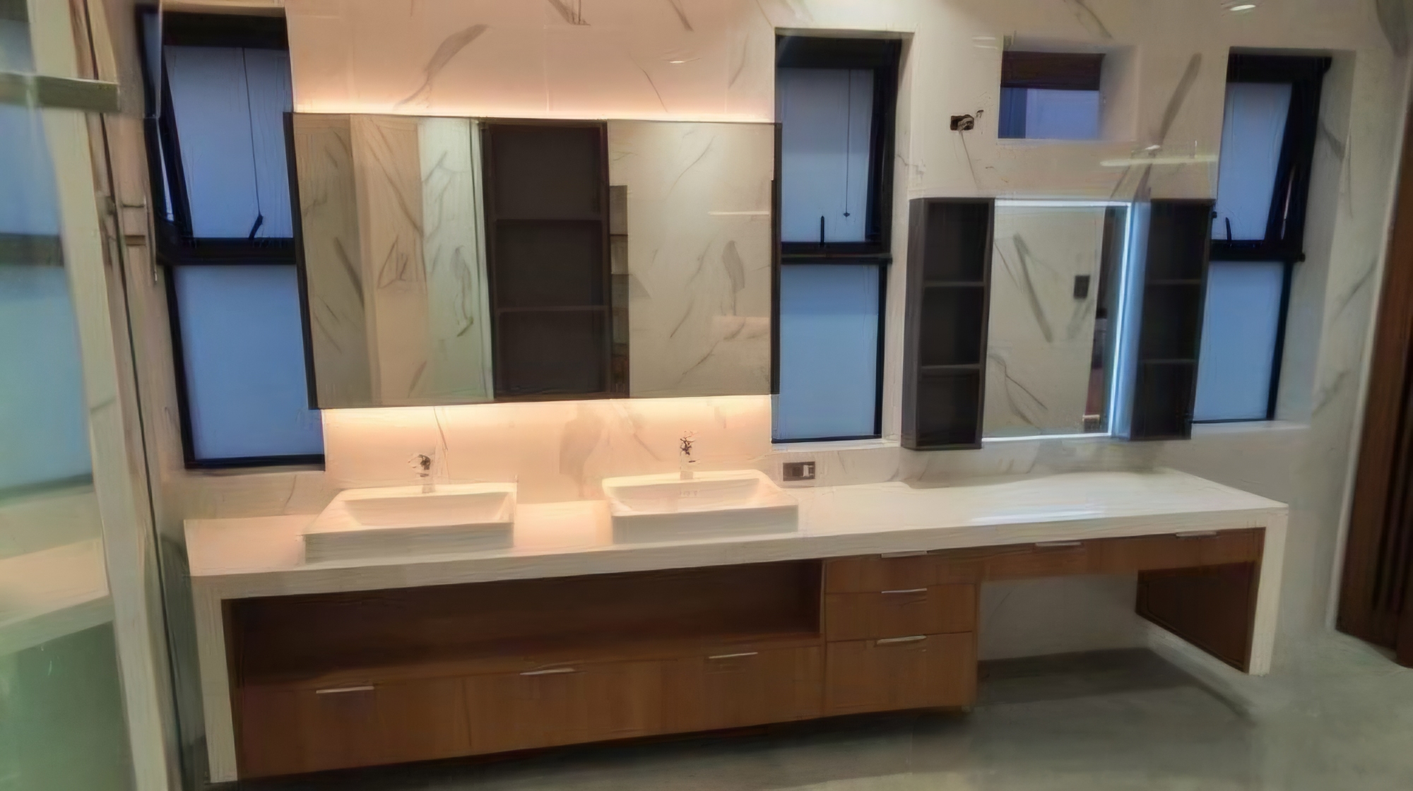 Marble double-vanity bathroom with backlit mirrors