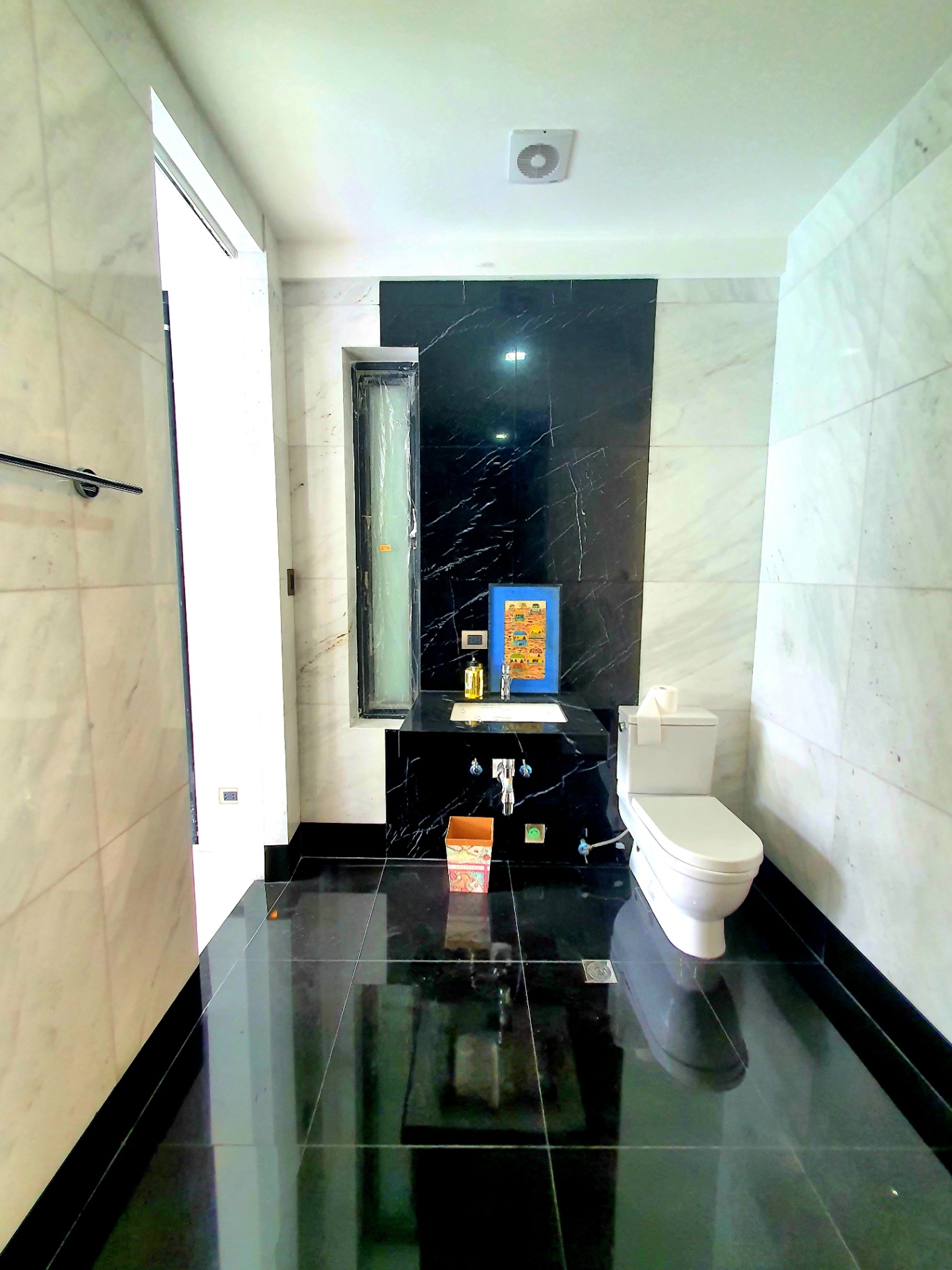 Marble bathroom with black stone feature wall