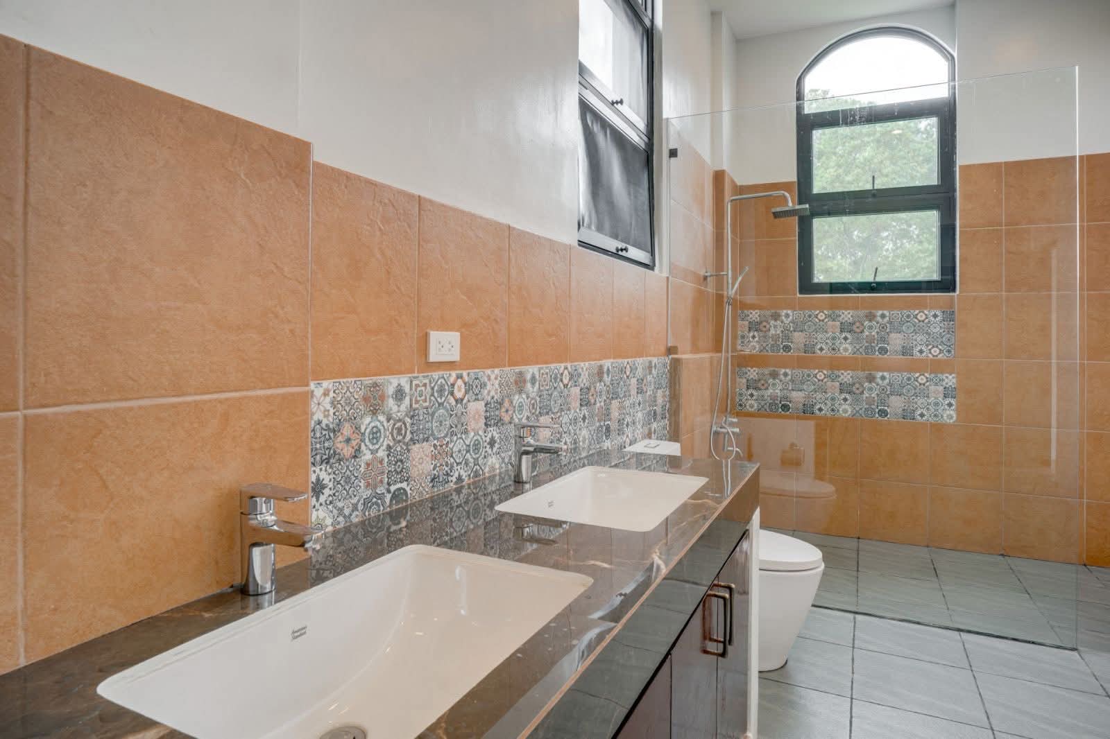 Modern en-suite bathroom with dual vanity and walk-in rain shower