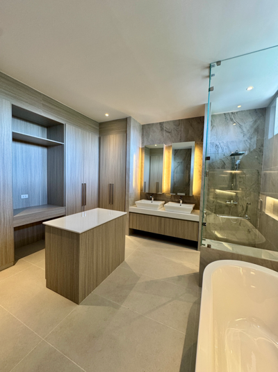 Master bath with double vanity, walk-in shower, and soaking tub