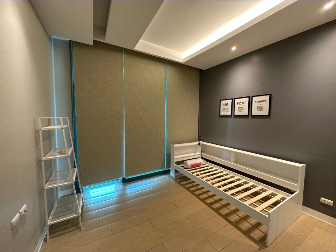 Second bedroom with cove lighting and framed motivational prints