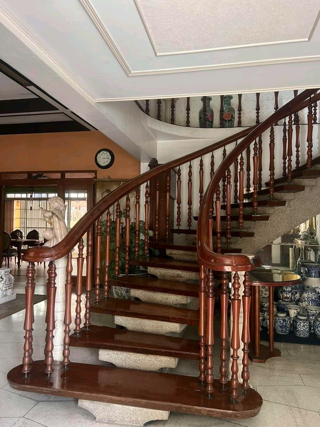 Grand curved narra staircase in the entrance hall