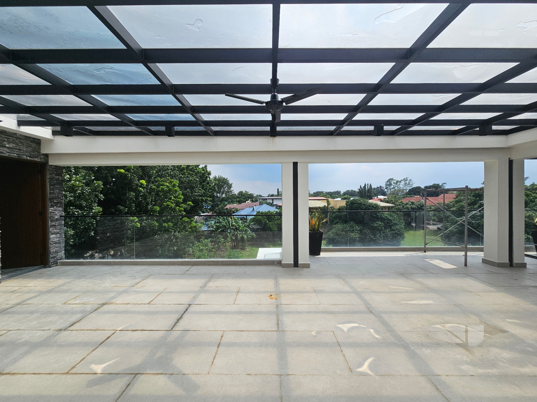 Open roof deck lounge with skylight canopy and village views