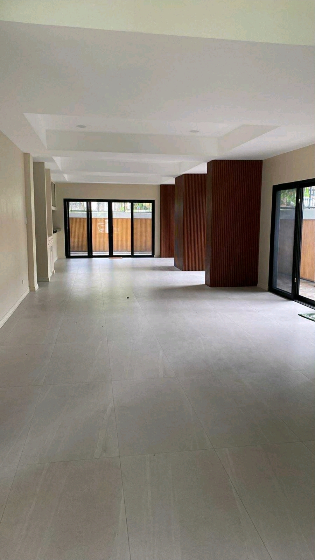 Wide family living area with large sliding doors and wood-accent walls