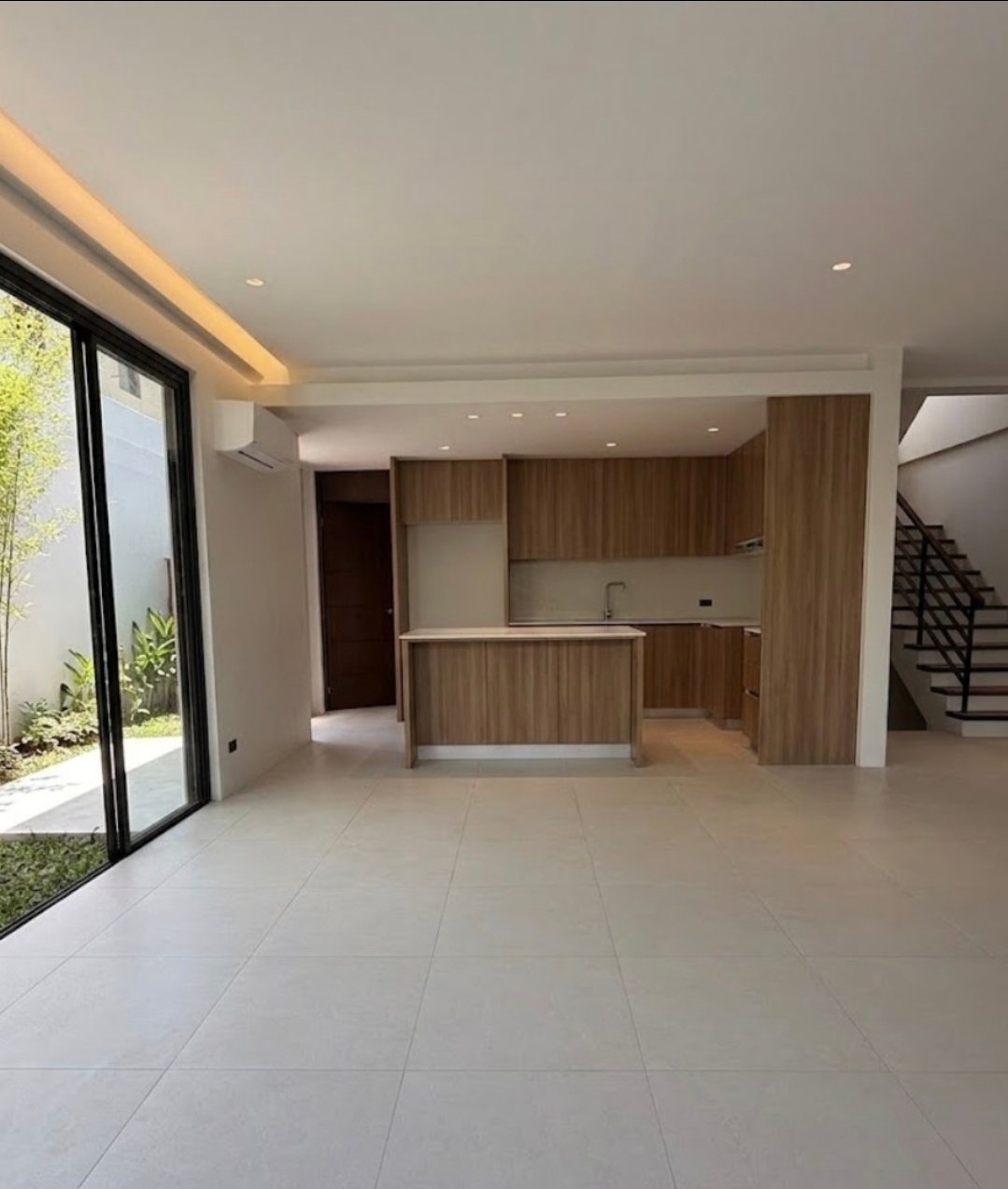 Clean kitchen with island and full-height glass opening to the garden