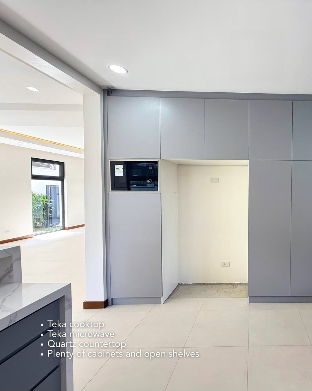 Built-in cabinets and Teka microwave in the kitchen