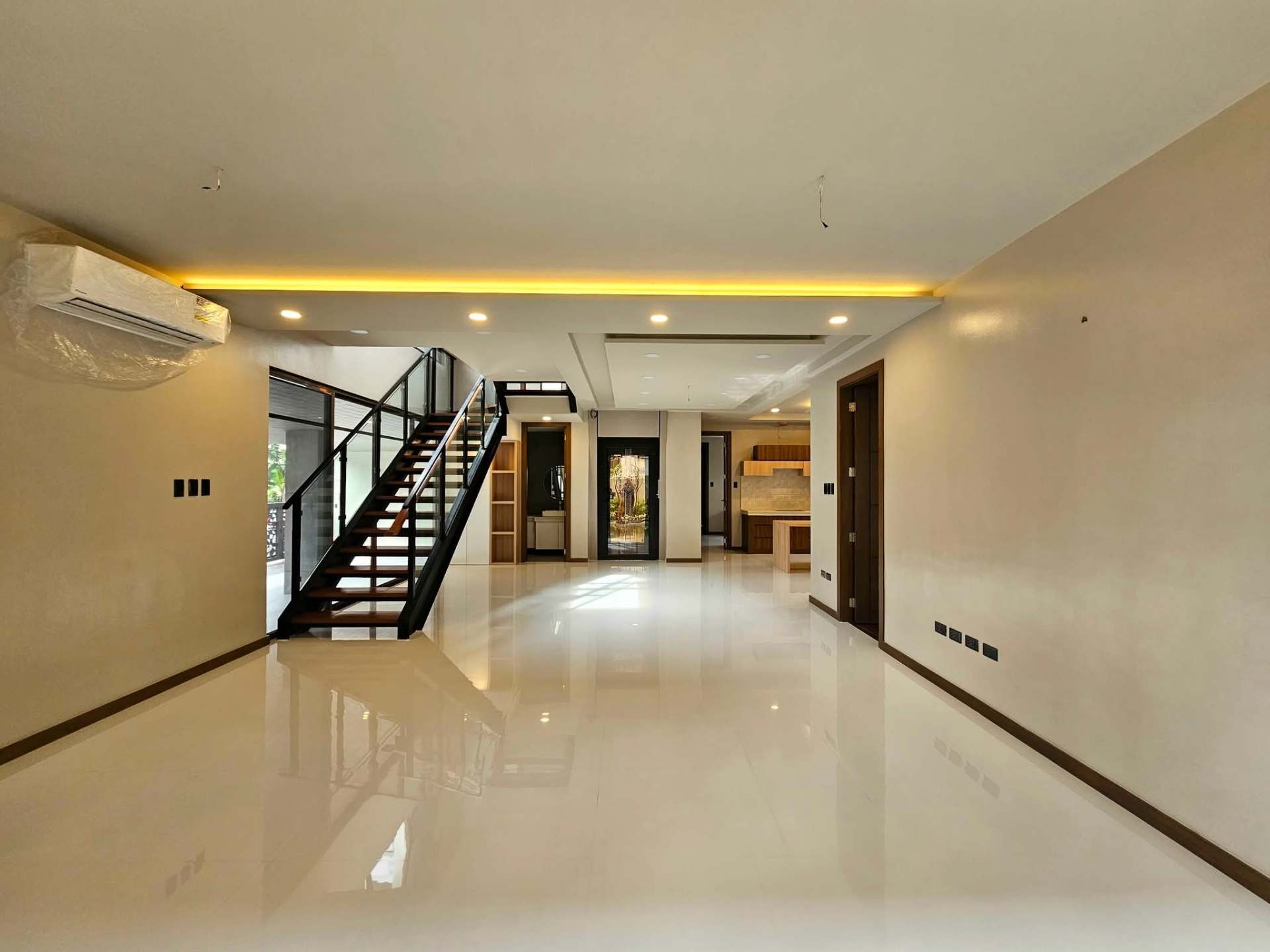 Open living area with floating staircase