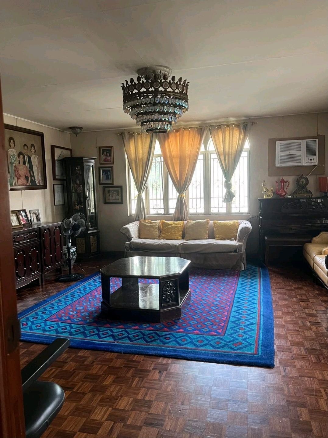 Family living room with arched windows and hardwood floors