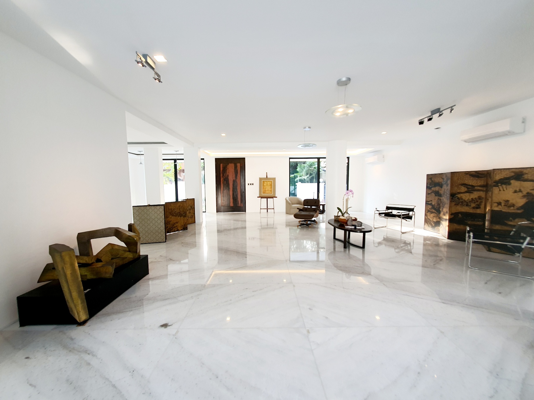 Grand gallery-style living area with polished marble floors