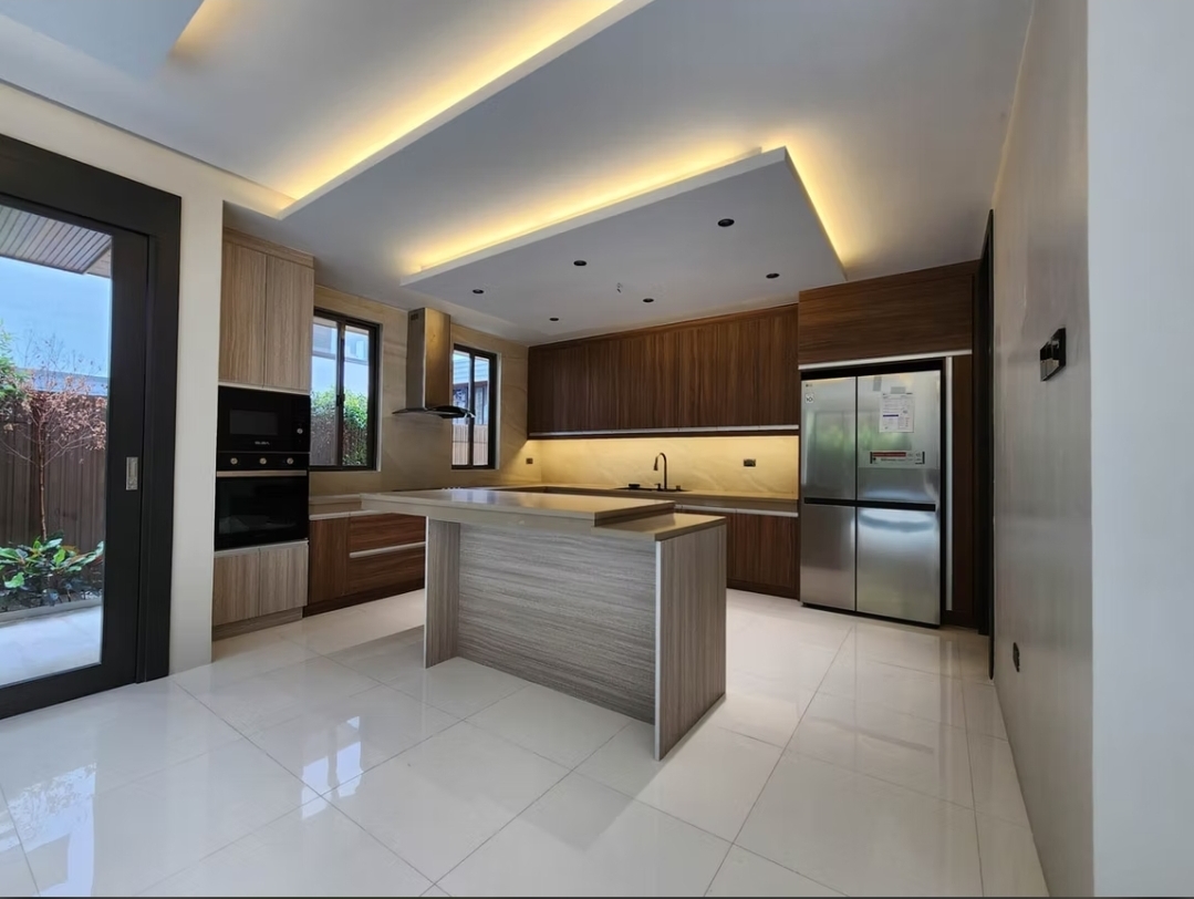 Main kitchen with dark wood cabinetry, island, and built-in appliances