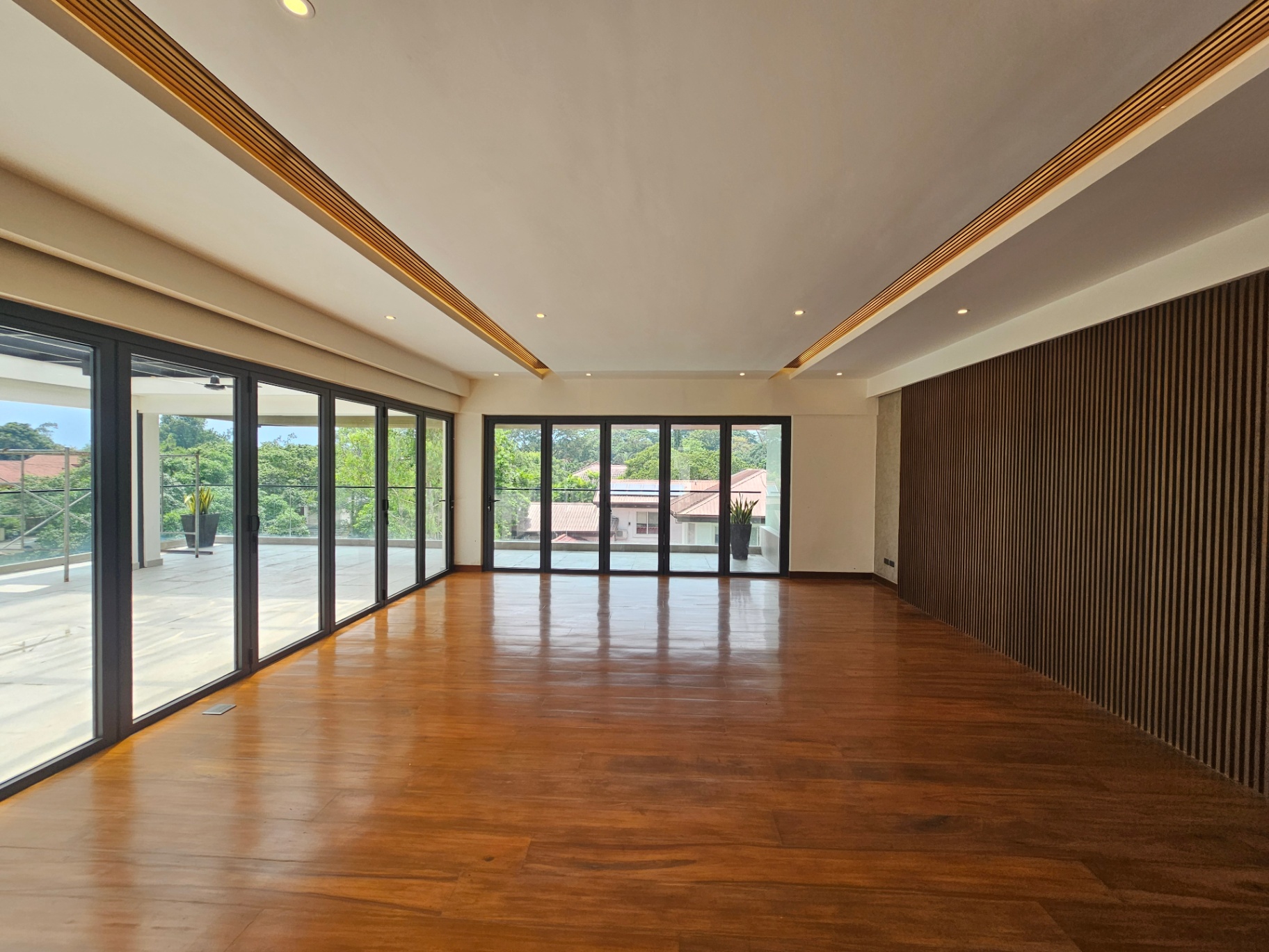 Spacious upper floor room with wood floors and terrace access
