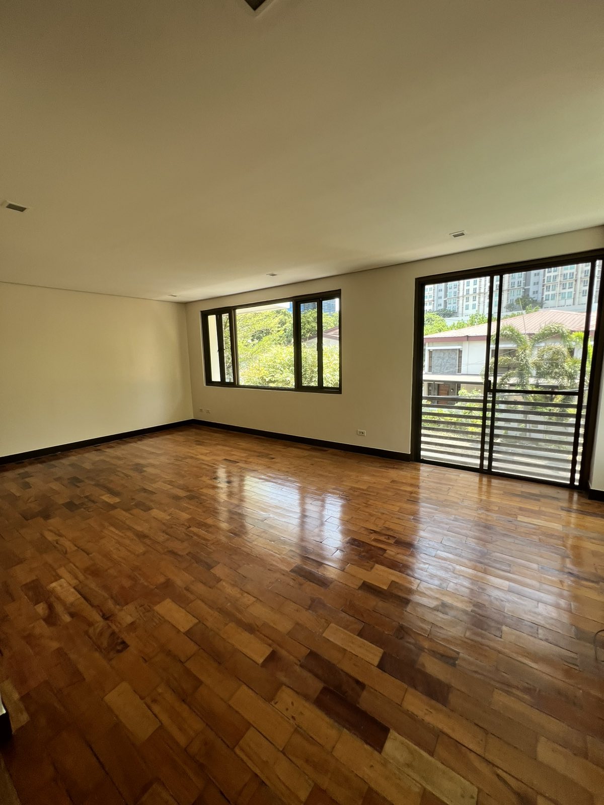 Large bedroom with balcony access and city-edge views