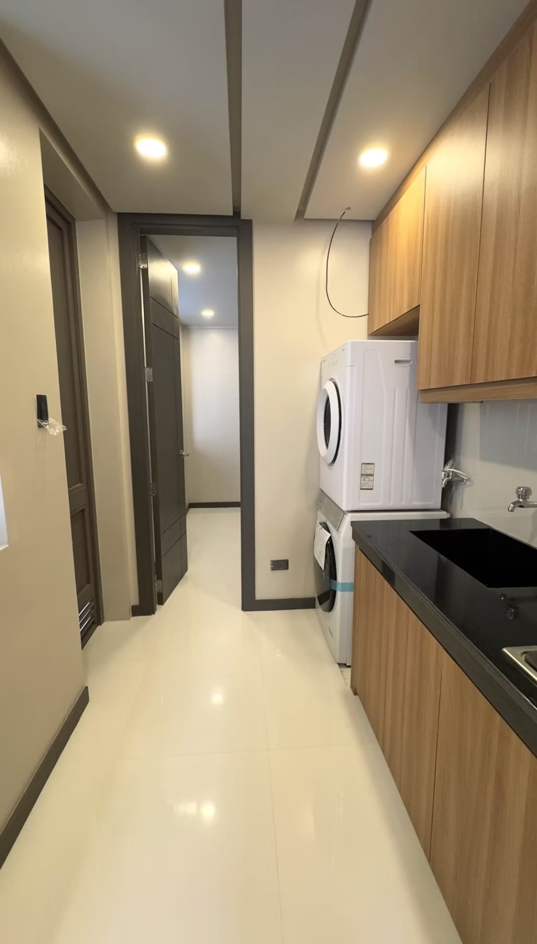 Service hallway with utility area and maid's room access