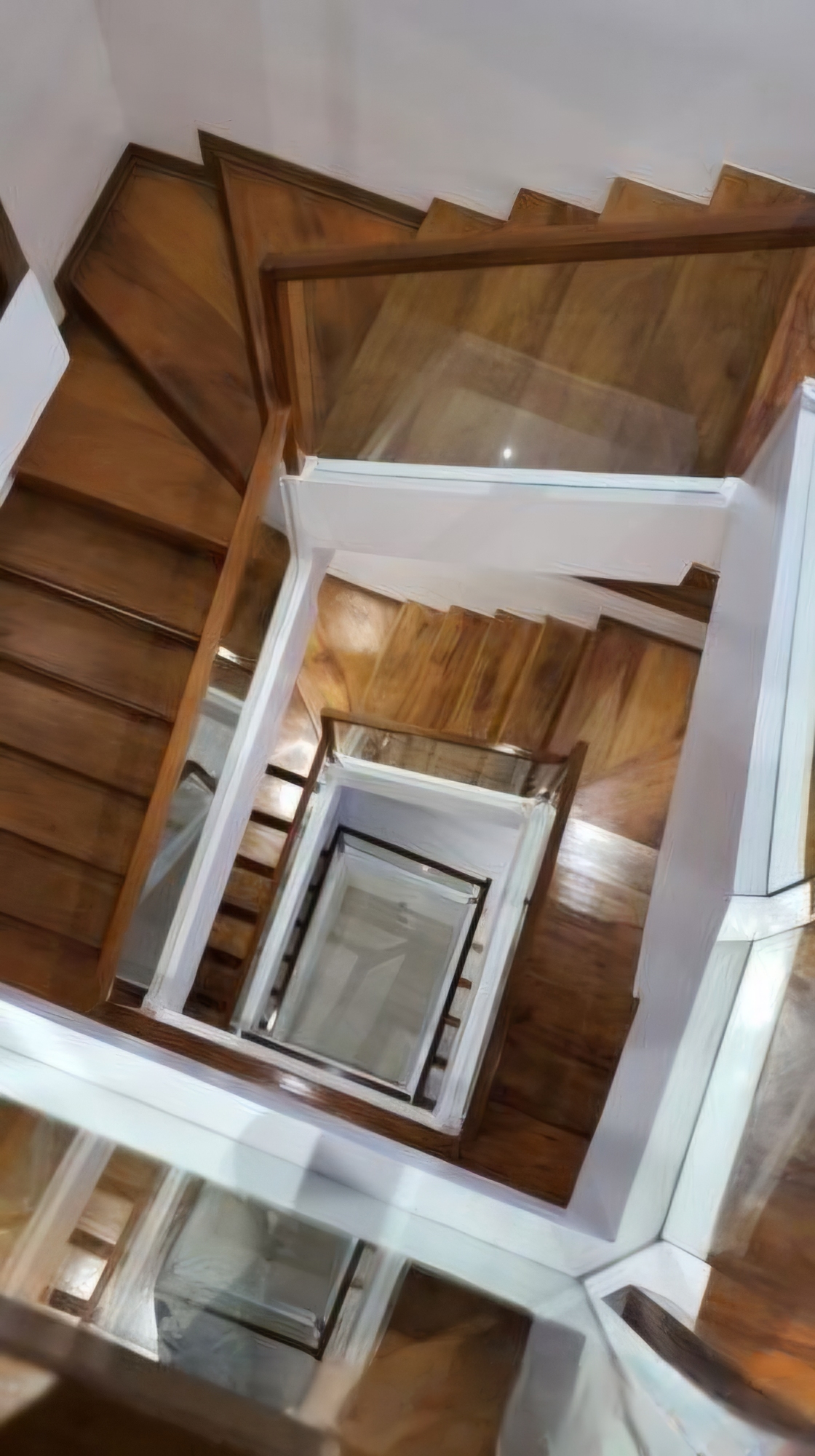 View down the sculptural hardwood staircase