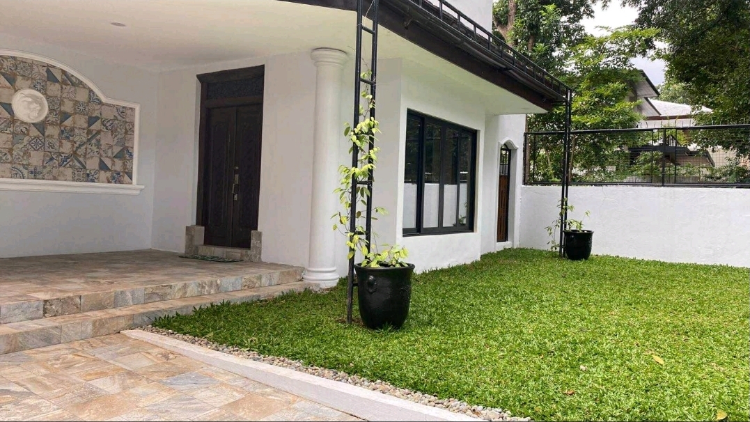 Covered porch and garden beside the main entrance