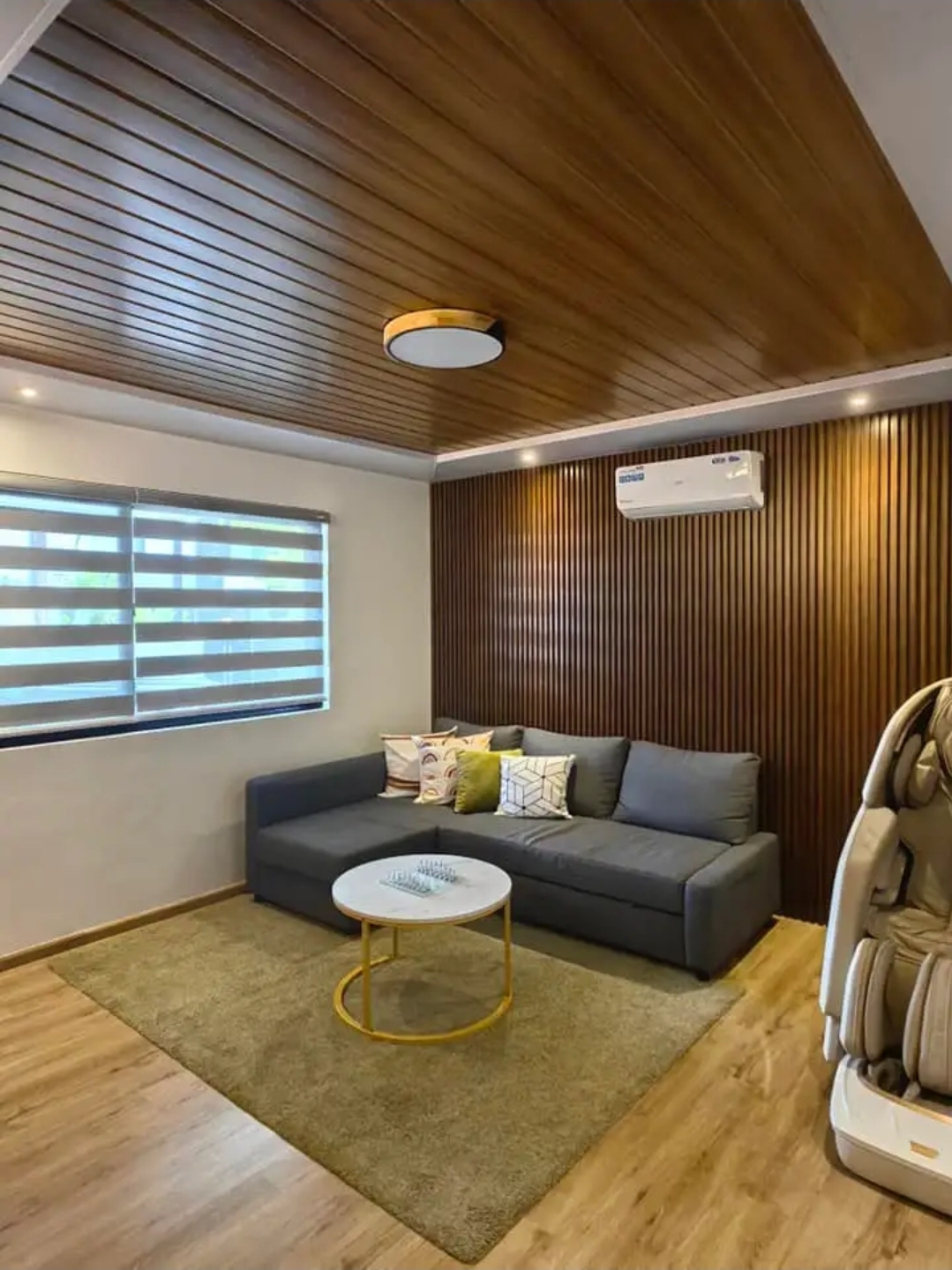 Ground floor movie room with sectional sofa and massage chair